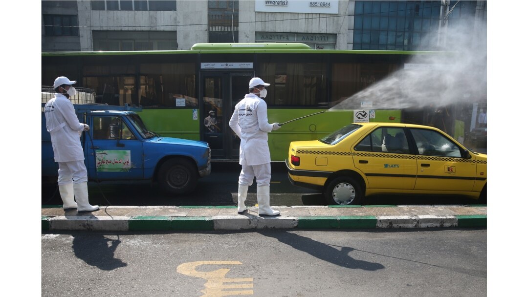 A worker sanitizes a taxi cab in Tehran, Iran, March 05, 2020. (WANA via Reuters)