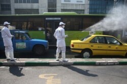 A worker sanitizes a taxi cab in Tehran, Iran, March 05, 2020. (WANA via Reuters)