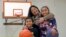  Lara Mae Chollette, a coach of youth soccer and basketball, poses for a photo with her son Jaylen, 7, left, and daughter Linda, 10, at a community gym in Seattle.