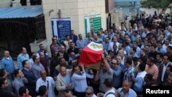 People carry the coffin of Egyptian police officer Ahmed Fayez, who was attacked with other security forces by militants in Egypt's western desert, in El Hosary Mosque outside Cairo, Oct. 21, 2017.