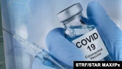 FILE - A sign for a COVID-19 vaccine is seen in White Plains, N.Y. 