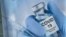 FILE - A sign for a COVID-19 vaccine is seen in White Plains, N.Y. 