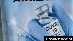 A sign for a COVID-19 vaccine is seen in White Plains, N.Y. Johnson & Johnson said Aug. 25, 2021, that a booster shot for its vaccine after six months may have big benefits. 