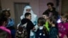 A boy hugs a man wearing a St. Nicholas costume during celebrations of St. Nicholas Day in Izium, Ukraine, Dec. 6, 2024. 