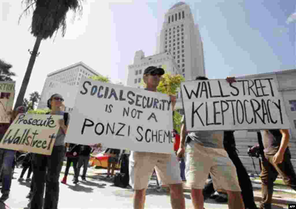People protesting Wall Street greed, corporate corruption and related issues continue their campout on the lawn of Los Angeles City Hall, in concert with demonstrations in other cities including New York, Monday, Oct. 3, 2011. (AP Photo/Reed Saxon)