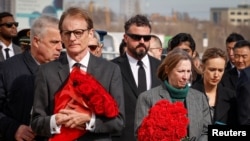 FILE - British Charge d'Affaires Tom Dodd and U.S. Ambassador Lynne Tracy attend a ceremony by ambassadors in memory of the victims of the terror attack in Krasnogorsk, outside Moscow, March 30, 2024. Russian propaganda has tried to link Ukraine and the U.S. to the attack.