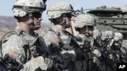 U.S. Army soldiers from Stryker Brigade Combat Team stand in line after a live fire drill during joint exercises with South Korea. (2011 File)