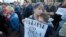 A woman holds a poster that reads: "Elections are when you can choose," as people gathered for a protest in St. Petersburg, Russia, Sept. 5, 2019. 
