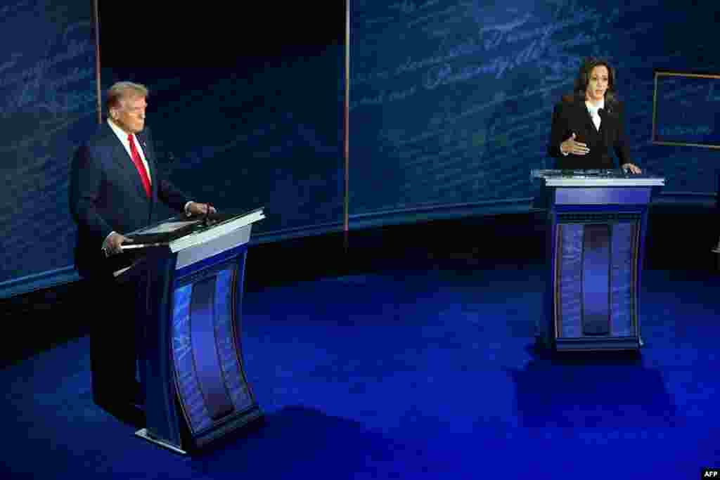 US Vice President and Democratic presidential candidate Kamala Harris (R) speaks during a presidential debate with former US President and Republican presidential candidate Donald Trump at the National Constitution Center in Philadelphia, Pennsylvania, on