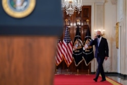 President Joe Biden approaches the podium to speak about the end of the war in Afghanistan from the State Dining Room of the White House, Aug. 31, 2021, in Washington.