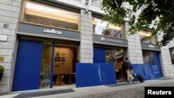 A man walks inside the Italian coffee roaster Lavazza's flagship store set to open in autumn, in downtown Milan, Italy, Sept. 15 2017.