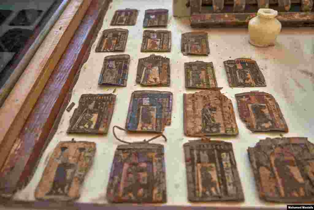 Strips of papyrus dating to the Late Period, each bearing depictions of the goddess Taweret as a hippopotamus with the tail of a crocodile ,standing in front of a column of hieroglyphic writing. (H. Elrasam/VOA) 