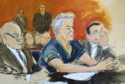 In this courtroom artist's sketch, defendant Jeffrey Epstein, center, sits with attorneys during his arraignment in New York federal court, July 8, 2019.