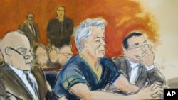 In this courtroom artist's sketch, defendant Jeffrey Epstein, center, sits with attorneys Martin Weinberg, left, and Marc Fernich during his arraignment in New York federal court, July 8, 2019. 