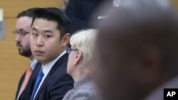 Police officer Peter Liang, second from left, sits with his legal team in his trial on charges in the shooting death of Akai Gurley at Brooklyn Supreme court in New York, Feb. 11, 2016. 