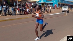 FILE -Rebecca Cheptegei, competes at the Discovery 10km road race in Kapchorwa, Uganda, Jan. 20, 2023.