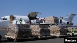 FILE - Workers unload an aid shipment from a plane at the Sanaa airport, Yemen, Nov. 25, 2017. 
