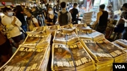 A newspaper seller in Hong Kong selling more than 10,000 copies of Apple Daily.