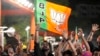 Modi set to win narrow majority, but his party’s numbers slide