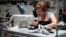 A worker sews clothes at the Karen Kane clothing company in Los Angeles, California, Jun. 30, 2011. The Los Angeles apparel industry is riding a small but growing wave of incoming jobs as costs in China and India rise.