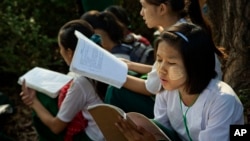 FILE - Students prepare for an exam in suburbs of Yangon, Myanmar, Feb. 19, 2016. 