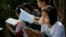 FILE - Students prepare for an exam in suburbs of Yangon, Myanmar, Feb. 19, 2016. 