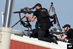 Police snipers return fire after shots were fired while Republican presidential candidate former President Donald Trump was speaking at a campaign event in Butler, Pennsylvania, July 13, 2024.