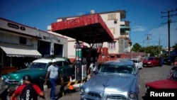 FILE - Cars line up to buy fuel at a gas station in Havana, Cuba, July 19, 2019. 