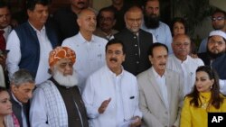 Former Prime Minister Yousuf Raza Gilani (Front-C) a leader in the Pakistan People's Party, and other Pakistani politicians speak to journalists after their meeting in Islamabad, Pakistan, July 30, 2018.