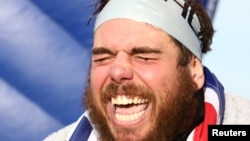 Swimmer Ross Edgley reacts after completing his round-Britain swim, on Margate beach, Britain Nov. 4, 2018. 