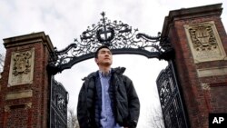 FILE - Harvard University graduate Jin K. Park, who holds a degree in molecular and cellular biology, poses at a gate at Harvard Yard in Cambridge, Massachusetts, Dec. 13, 2018. Park was among last year's Rhodes scholars. 