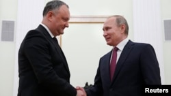 Russian President Vladimir Putin, right, shakes hands with his Moldovan counterpart Igor Dodon during a meeting at the Kremlin in Moscow, Jan. 17, 2017.