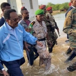 President of Somalia Mohamed Abdullahi Farmajo wades through flood waters in Beledweyn, Somalia November 2, 2019 in this still image obtained from social media video on November 4, 2019.