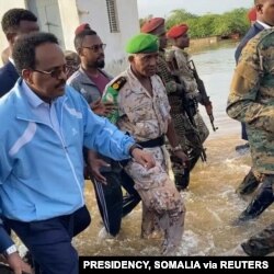 FILE - Somalia's President Mohamed Abdullahi Farmajo wades through flood waters in Beledweyn, Somalia November 2, 2019 in this still image obtained from social media video on Nov. 4, 2019.