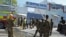 Somali security forces, paramedics and firefighters stand outside the Central Hotel, close to the presidential palace, in Mogadishu, Feb. 20, 2015. 