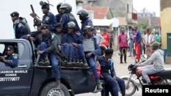 FILE-Police sit in a pickup vehicle in front of Notre Dame Cathedral in Kinshasa, Democratic Republic of Congo, Feb. 25, 2018. 