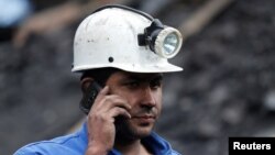 A rescue personnel helps coordinate a search for missing miners, June 24, 2017, after an explosion at an underground coal mine in Cucunuba, Colombia.