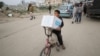 A Palestinian boy carries an aid box provided by UNRWA, amid a ceasefire between Hamas and Israel, in Gaza City, Feb. 3, 2025. 