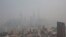 FILE - The financial district of Pudong is seen on a hazy day in Shanghai, March 18, 2014.