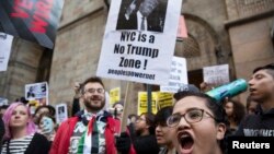 FILE - Protesters demonstrate against Republican U.S. presidential candidate Donald Trump in midtown Manhattan in New York City, April 14, 2016. 