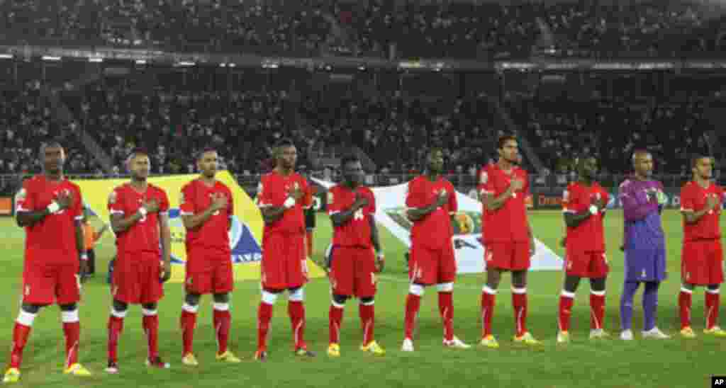 Equatorial Guinea national soccer team players listen to their national anthem before the start of their match against Libya during the opening match at the African Nations Cup soccer tournament in Estadio de Bata "Bata Stadium", in Bata January 21, 2012.