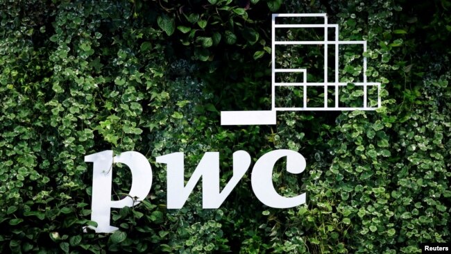 FILE - The logo of accounting firm PricewaterhouseCoopers (PwC) is seen on a board at the St. Petersburg International Economic Forum, Russia, June 6, 2019.