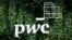 FILE - The logo of accounting firm PricewaterhouseCoopers (PwC) is seen on a board at the St. Petersburg International Economic Forum, Russia, June 6, 2019.