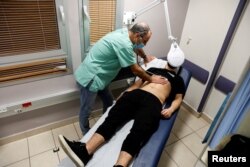 FILE PHOTO: A patient suffering from Long COVID is examined in the post-coronavirus disease (COVID-19) clinic of Ichilov Hospital in Tel Aviv