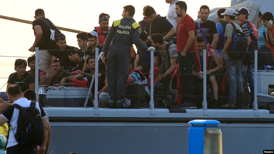 Migrants are seen onboard an Italian Coast Guard vessel following a rescue operation at the port on the Greek island of Kos, Aug. 16, 2015. 