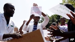 A group of Zimbabwean doctors sing as they protest at Parirenyatwa hospital in Harare, Zimbabwe, Sept. 15, 2019. 