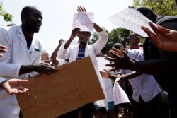 FILE - A group of Zimbabwean doctors sing as they protest at Parirenyatwa hospital in Harare, Zimbabwe, Sept. 15, 2019.