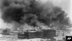 FILE - In this 1921 image provided by the Library of Congress, smoke billows over Tulsa, Okla.