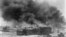 FILE - In this 1921 image provided by the Library of Congress, smoke billows over Tulsa, Okla.