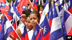 FILE - Students holding Taiwanese and Nicaraguan flags take part in a farewell ceremony for Taiwan's President Chen Shui-bian, in Managua, Nicaragua, Aug. 28, 2007.